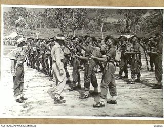 NEW GUINEA. 1943-11-20. THE GUARD OF THE 2/9TH AUSTRALIAN INFANTRY BATTALION BEING INSPECTED DURING THE BRIGADE GUARD MOUNTING CHAMPIONSHIPS AT THE 18TH AUSTRALIAN INFANTRY BRIGADE SPORTS MEETING ..