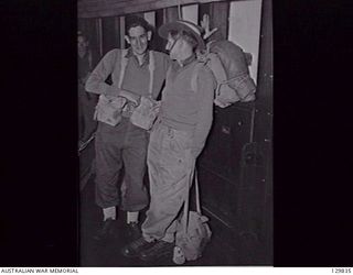 DARLING HARBOUR, NSW. 1946-06-21. NX176126 CORPORAL M. J. CORRIGAN AND NX17740 SAPPER K. BAILEY CHAT WHILE WAITING TO DISEMBARK FROM HMAS MANUNDA AFTER ITS ARRIVAL FROM RABAUL