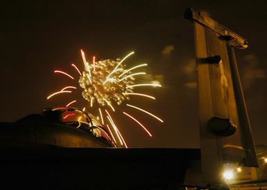 A view from onboard the flight deck of the US Navy (USN) Nimitz Class Aircraft Carrier USS ABRAHAM LINCOLN (CVN 72), showing fireworks lighting up the night sky, during an Independence Day Celebration at Navy Base (NB) Pearl Harbor, Hawaii (HI)). The LINCOLN and Combat Carrier Strike Group 9 (CSG-9) are currently in the Hawaiian Operations Area to participate in the month-long Rim of the Pacific (RIMPAC) 2006 Exercises. RIMPAC brings together military forces from Australia, Canada, Chile, Peru, Japan, the Republic of Korea, the United Kingdom and the US