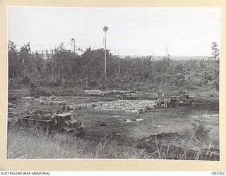 CAPE WOM, WEWAK AREA, NEW GUINEA, 1945-07-02. THE PETROL DUMP AT 2/22 SUPPLY DEPOT PLATOON SHOWING A SECTION OF THE 120,000 GALLONS IN STORAGE. THE TRUCK IS BEING LOADED WITH 44-GALLON DRUMS FOR ..