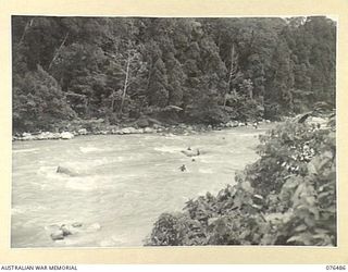 BUSU RIVER, NEW GUINEA. 1944-10-07. PERSONNEL OF THE 2/8TH CAVALRY COMMANDO SQUADRON ADOPTING THE "BOUNCING" TECHNIQUE TO CROSS THE SWIFT FLOWING RIVER DURING AN ARMY-AIR CO-OPERATION EXERCISE WITH ..