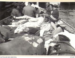 LAE, NEW GUINEA. 1944-08-18. SICK AND WOUNDED AUSTRALIAN ARMY PERSONNEL ABOARD A LIFEBOAT IN TRANSIT BETWEEN THE WHARF AND THE 2/1ST HOSPITAL SHIP, "MANUNDA"
