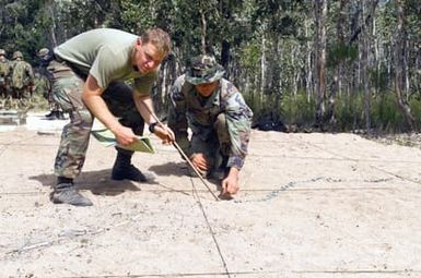 US Marine Corps (USMC) Corporal (CPL) Duffy (left) and USMC CPL Roedema, Headquarters and Service Company, 2nd Battalion, 3rd Marine Regiment (2/3), Marine Corps Base Hawaii (MCBH), Hawaii (HI), make the finishing touches on a terrain model at CROCODILE 2003
