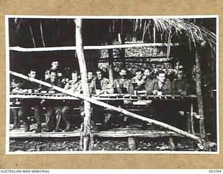 FAITA, NEW GUINEA. 1944-01-07. MEMBERS OF THE 2/2ND COMMANDO SQUADRON ENJOYING BREAKFAST IN THEIR MESS AT HEADQUARTERS. SHOWN ARE: TROOPER J. R. SMITH (1); SERGEANT F. W. BRYANT (2); LANCE SERGEANT ..