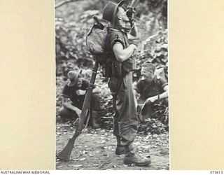 MARUKINAM, NEW GUINEA. 1944-05-27. N446973 PRIVATE C.A. COATES, B COMPANY, 35TH INFANTRY BATTALION (2), DRINKING FROM HIS WATER BOTTLE DURING A PAUSE IN THE ADVANCE ALONG THE COAST TOWARDS WEWAK. ..