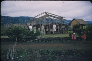 The framework of the parasitology laboratory with the men who carried it : Minj Station, Wahgi Valley, Papua New Guinea, 1954 / Terence and Margaret Spencer