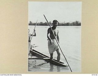 ALEXISHAFEN, NEW GUINEA. 1944-05-11. NX121145 SIGNALMAN J. PRINCE ( ), AND NX112011 SIGNALMAN A. DEITCH ( ), MEMBERS OF THE 8TH INFANTRY BRIGADE SIGNALS, SPEARING FISH FROM A NATIVE CANOE