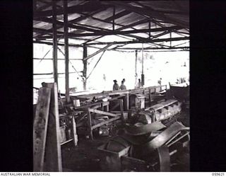 DONADABU, NEW GUINEA. 1943-11-09. INTERIOR OF THE EILOGO SAWMILL WHICH IS OPERATED BY THE 9TH AUSTRALIAN WORKSHOP AND PARK COMPANY, ROYAL AUSTRALIAN ENGINEERS. ALL BELT DRIVES ARE ENCASED IN WOODEN ..