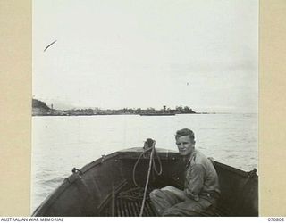 LABU, NEW GUINEA, 1944-03-03. NX137962 SAPPER R. PATRICK PICTURED IN A PINNACE APPROACHING LAE AFTER A 20 MINUTE RUN ACROSS THE MARKHAM RIVER