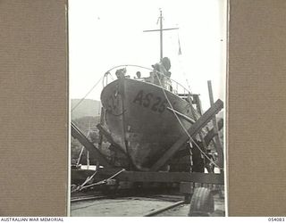 BALASANA, NEW GUINEA, 1943-07-06. NEW VESSEL NEARING COMPLETION ON THE SLIPWAYS OF THE 1ST AUSTRALIAN WATER TRANSPORT GROUP MAINTENANCE BASE