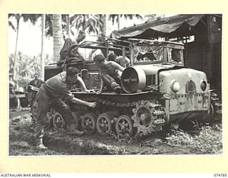 MILILAT, NEW GUINEA. 1944. PERSONNEL OF THE 231ST LIGHT AID DETACHMENT, ATTACHED TO HEADQUARTERS, 5TH DIVISION RECONDITIONING A CAPTURED JAPANESE TRACTOR