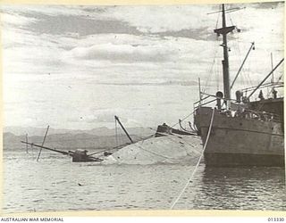 1942-10-01. NEW GUINEA. MILNE BAY. THIS ALLIED VESSEL WAS SUNK BY JAPANESE WARSHIPS DURING THE UNSUCCESSFUL JAPANESE ATTACK ON MILNE BAY