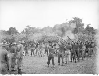 KIARIVU, NEW GUINEA, 1945-08-15. THE FUNERAL SERVICE OF THE LAST BATTLE CASUALTY OF 2/7 INFANTRY BATTALION, PRIVATE F.W. GAGE, WHICH WAS ATTENDED BY THE COMMANDING OFFICER AND HIS STAFF OFFICERS. ..