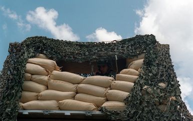 SPECIALIST Rivera, US Army (USA), 1ST Battalion, 17th Infantry Division mans a raised bunker position at Orote Point, Guam during Exercise TANDEM THRUST '99