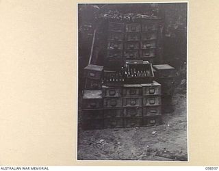 RABAUL, NEW BRITAIN. 1945-11-20. A STACK OF QUICK FIRING 2-POUND AUSTRALIAN NAVAL SHELLS WHICH WERE CAPTURED DURING THEIR INVASION OF THE ISLAND. THEY ARE NOW STORED IN 11 DIVISION AREA
