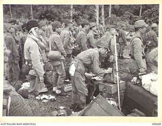 KAIRIRU ISLAND, NEW GUINEA. 1945-09-17. JAPANESE NAVAL OFFICERS WAITING TO BOARD BARGES FOR TRANSFER TO MUSCHU ISLAND. FOLLOWING THE SURRENDER OF THE JAPANESE THE ISLANDS ARE NOW UNDER THE CONTROL ..