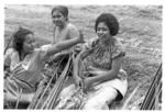 Women making baskets for food from the earth ovens.