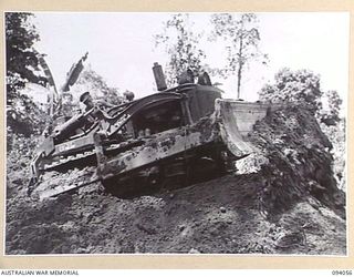 BOUGAINVILLE, 1945-07-16. A BULLDOZER, DRIVEN BY SAPPER H.F. THOMAS, 6 MECHANICAL EQUIPMENT COMPANY, ATTACHED 3 DIVISION, CLEARING AWAY THE TOP SOIL DURING THE CONSTRUCTION OF A 3-TONNER ROAD ..