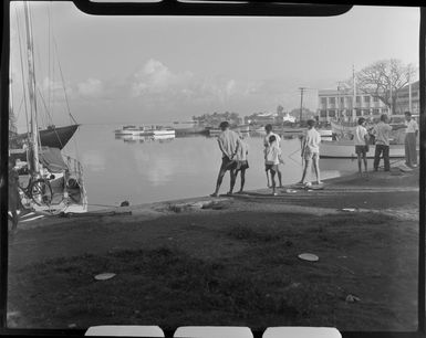 Papeete waterfront, Tahiti, showing local men and boys fishing