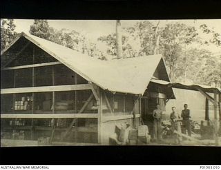 Torokina, Bougainville. 1944-11. The cookhouse used by No. 1 and No. 3 Section, Detached, 2 Field Survey Company. It was previously a US Forces kitchen. Left to right: Charlie Tregillis, Freddy ..