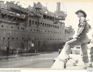 SIAR, NEW GUINEA. 1944-08-19. VX92262 LIEUTENANT A.C. PAUL, HEADQUARTERS, 7TH INFANTRY BRIGADE SADLY WATCHES HMT "KATOOMBA" PULLING OUT FROM THE WHARD AS SHE COMMENCED HER JOURNEY TO THE MAINLAND ..