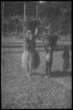 Burdened mother with children (2) : Goodenough Island, D'Entrecasteaux Islands, Papua New Guinea, 1956-1958 / Terence and Margaret Spencer