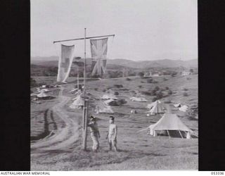 KOITAKI, NEW GUINEA. 1943-06-19. STAFF LIVING QUARTERS OF THE 2/2ND AUSTRALIAN CASUALTY CLEARING STATION CAMP. THE FOOTHILLS OF THE OWEN STANLEY RANGES ARE IN THE BACKGROUND. IN THE FOREGROUND ARE: ..