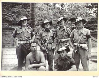 RABAUL, NEW BRITAIN. 1945-09-25. PERSONNEL OF 11 DIVISION PROVOST COMPANY AT A WAR CRIMINAL COMPOUND. IDENTIFIED PERSONNEL ARE:- PRIVATE A. RICHARDS (1); CORPORAL D. LEEDS (2); SERGEANT P. WALSH ..