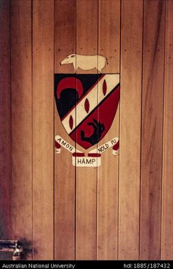 Black and red painted crest on a door