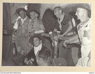 TOROKINA, BOUGAINVILLE. 1945-04-12/13. A CHORAL SCENE, INSTRUMENTAL AND VOCAL, SINGING COWBOY NUMBERS IN A CONCERT STAGED BY 45 MEMBERS OF 7 FIELD AMBULANCE FOR THE ENTERTAINMENT OF UNIT PERSONNEL, ..