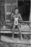 Carving: M'lapokala makes a wooden bowl with stand, probably for tourist trade