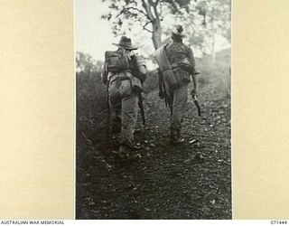 PORT MORESBY, NEW GUINEA, 1944-03-24. TWO AUSTRALIAN SOLDIERS POSING IN A PHOTOGRAPH TAKEN FOR V93667 CAPTAIN G.H. ALLEN, A SCULPTOR OF THE MILITARY HISTORY SECTION