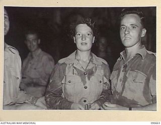 TOROKINA, BOUGAINVILLE. 1945-04-16. PRIVATE J. BRACEY (1), WITH CORPORAL T. KINGSTON (2), PAUSE DURING DANCING AT THE OTHER RANKS CLUB, HALSEY FIELD. THEY WERE AMONG COUPLES WHO WERE PREPARED TO ..