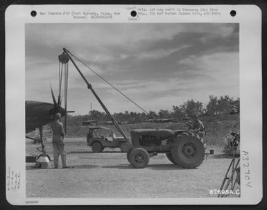 A Mechanized Hoist Is Hooked Tp A Propeller Which Men Of The 27Th Air Depot Group Are Removing From A Fighter Plane At The Port Moresby Air Depot, Papua, New Guinea. 1 October 1943. (U.S. Air Force Number 67698AC)