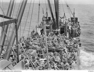 SIPAAI, BOUGAINVILLE ISLAND. 1945-01-07. TROOPS OF THE 31/51ST INFANTRY BATTALION RELAXING ABOARD THE AV1361 "POOLTA" AS SHE APPROACHES THE MOUTH OF THE KAIKARA RIVER WHERE THE UNIT IS MAKING A ..