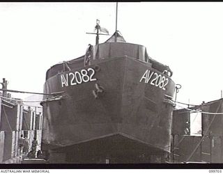 RABAUL, NEW BRITAIN, 1946-01-30. A PREFABRICATED FLOATING DOCK, 400 TONS, WAS ASSEMBLED BY 13 WATER TRANSPORT WORKSHOPS, CORPS OF AUSTRALIAN ELECTRICAL AND MECHANICAL ENGINEERS, AT RABAUL. PARTS ..