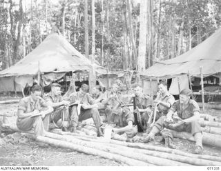 WAREO, NEW GUINEA, 1944-03-20. MEMBERS OF THE 29/46TH INFANTRY BATTALION CLEANING EQUIPMENT AND WRITING LETTERS DURING A PAUSE IN STRENUOUS TRAINING. IDENTIFIED PERSONNEL ARE: VX143697 PRIVATE R.D. ..
