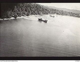MANOKWARI, NEW GUINEA. 1944-04. SINKING OF JAPANESE SHIPS. A RAAF BOMBER BOSTON BOMBER AIRCRAFT CAN BE SEEN OVER THE FIRST FLOATING SHIP