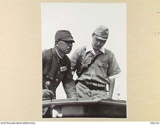 CAPE WOM, NEW GUINEA, 1945-09-13. LIEUTENANT-GENERAL ADACHI, COMMANDER 18 JAPANESE ARMY IN NEW GUINEA, SIGNING THE INSTRUMENT OF SURRENDER. HE ACCEPTED THE TERMS UNCONDITIONALLY. LIEUTENANT-GENERAL ..