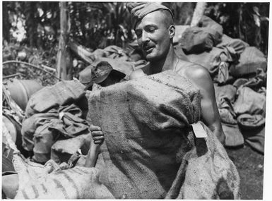 World War 2 New Zealand soldier, loading mail on the Treasury Islands, Solomon Islands