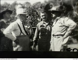 AITAPE, NORTH EAST NEW GUINEA. C. 1944-06. LEFT TO RIGHT: ARTHUR DRAKEFORD, THE MINISTER FOR AIR, JOHN DEDMAN, THE MINISTER FOR WAR ORGANISATION OF INDUSTRY, AND AIR COMMODORE F. R. W. SCHERGER, ..