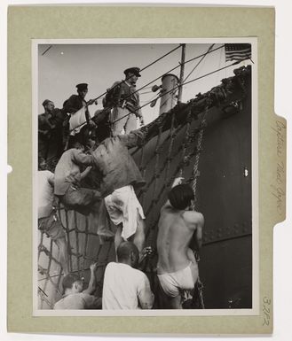 Photograph of Japanese Prisoners Climbing Aboard Coast Guard-manned Transport