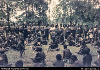 Mendi males sitting in a circle