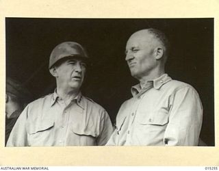 1943-07-12. AMERICAN ADVANCE INTO TROBRIAND ISLANDS. LT. GENERAL WALTER KRUEGAR TALKING WITH MAJOR GENERAL MCNIDER AT MILNE BAY AIRSTRIP WHILE WAITING THE ARRIVAL OF GENERAL MCARTHUR WHO FLEW TO ..