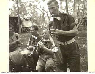 GUSIKA, NEW GUINEA, 1944-03-17. A SECTION OF "TRENKNER'S TROUBADOUR BAND", FORMED BY MEMBERS OF THE 29/46TH INFANTRY BATTALION, 4TH INFANTRY BRIGADE USING INSTRUMENTS CONTRIVED FROM .303 ..