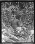 Woman, sitting on rock