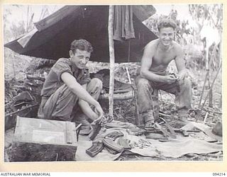 MOLONEY'S RIDGE, WEWAK, NEW GUINEA. 1945-07-13. PRIVATE C.A. BROWN (1) AND CORPORAL G.R. CASEY (2), MEMBERS OF A COMPANY, 2/5 INFANTRY BATTALION, RELOAD THEIR BREN AND OWEN GUN MAGAZINES AFTER THE ..