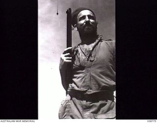 DUMPU, NEW GUINEA. 1943-10-07. BEARDED SOLDIER NX21939 TROOPER T. P. MARTIN OF THE 2/2ND AUSTRALIAN INDEPENDENT COMPANY ON HIS RETURN TO CAMP AFTER A TWELVE DAY PATROL IN THE RAMU VALLEY