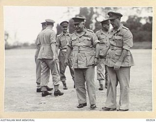 TOROKINA, BOUGAINVILLE. 1945-06-08. GENERAL SIR THOMAS A. BLAMEY, COMMANDER-IN-CHIEF, ALLIED LAND FORCES, SOUTH WEST PACIFIC AREA (1), BEING GREETED BY LIEUTENANT GENERAL S. G. SAVIGE, GENERAL ..