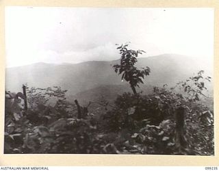 TOL, WIDE BAY, NEW BRITAIN, 1945-12-01. VIEW OF PERRY'S KNOLL LOOKING NORTH, SHOWING MOUNTAINOUS BACKGROUND. PHOTOGRAPH TAKEN TO AID IN THE CONSTRUCTION OF A MODEL FOR THE AUSTRALIAN WAR MEMORIAL ..